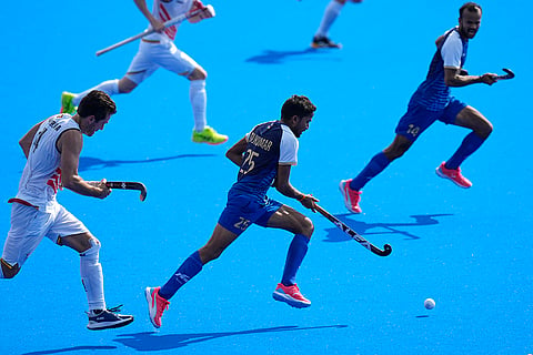 Rajkumar Pal drives the ball up the pitch against Belgium